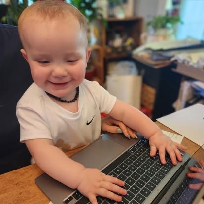 A happy toddler at the desk of the family-owned Bright Heating and Cooling